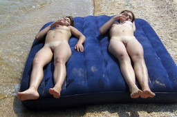 Two hot nude girls having fun on